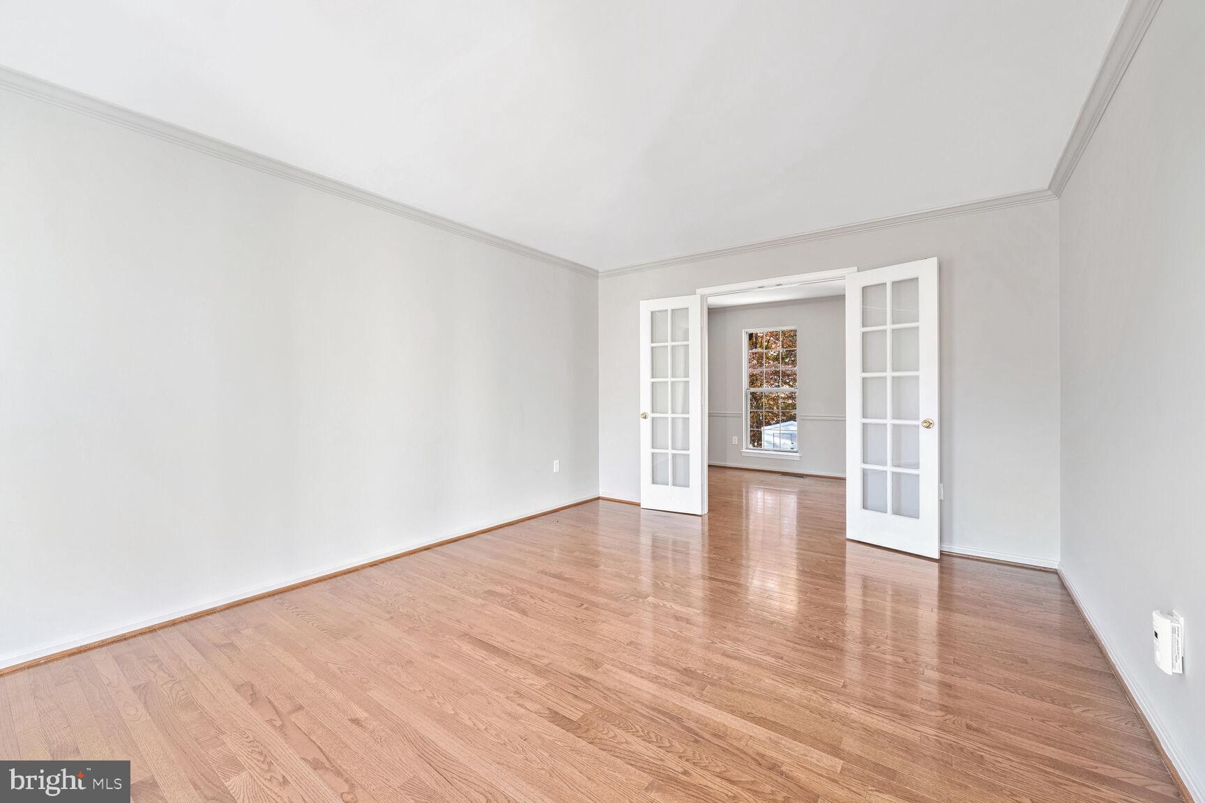 501 Dobbin Court Accokeek, MD 20607 - Photo 11 of 38 a view of an empty room with wooden floor and windows