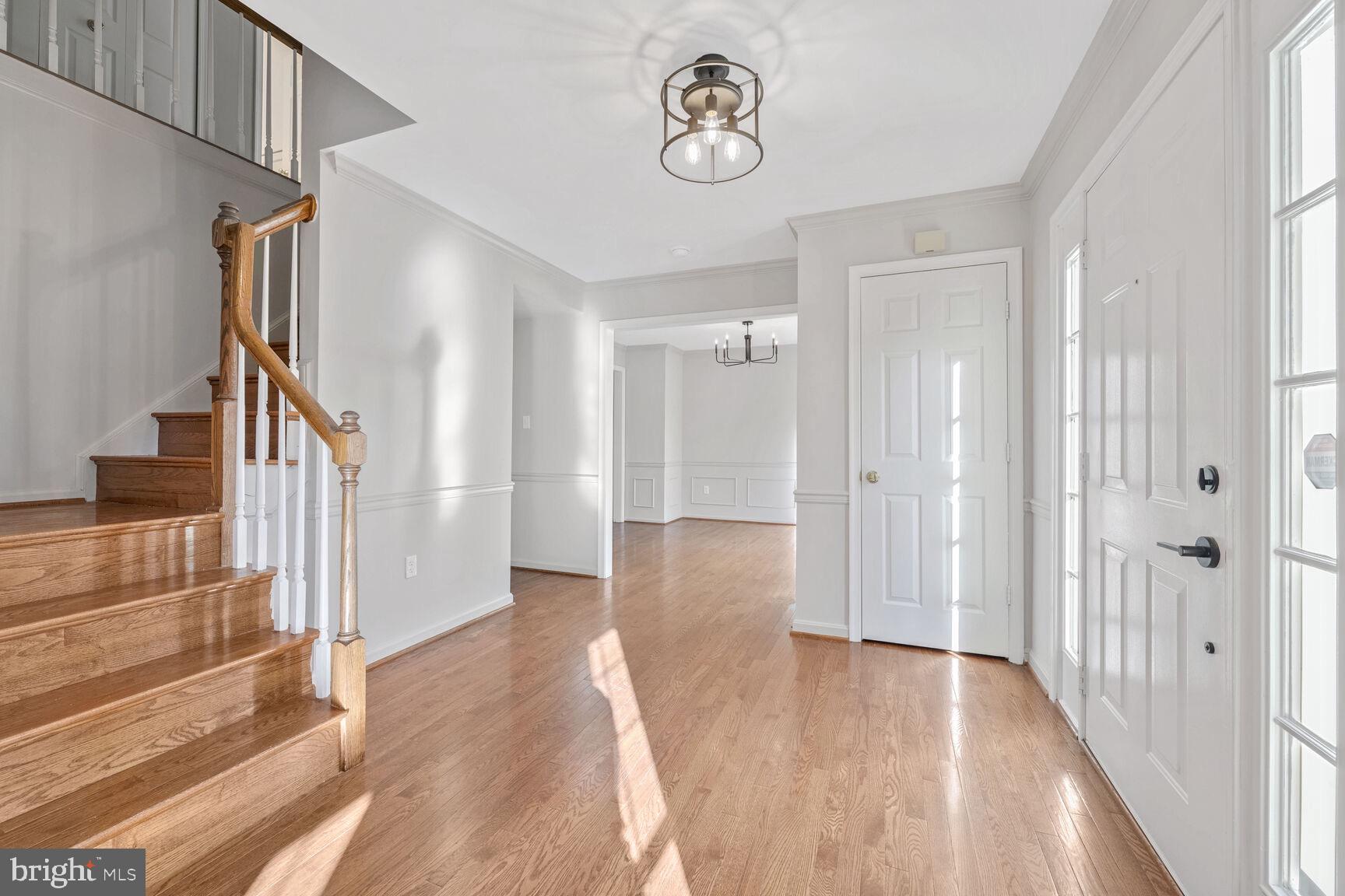 501 Dobbin Court Accokeek, MD 20607 - Photo 10 of 38 a view of a hallway with wooden floor and staircase
