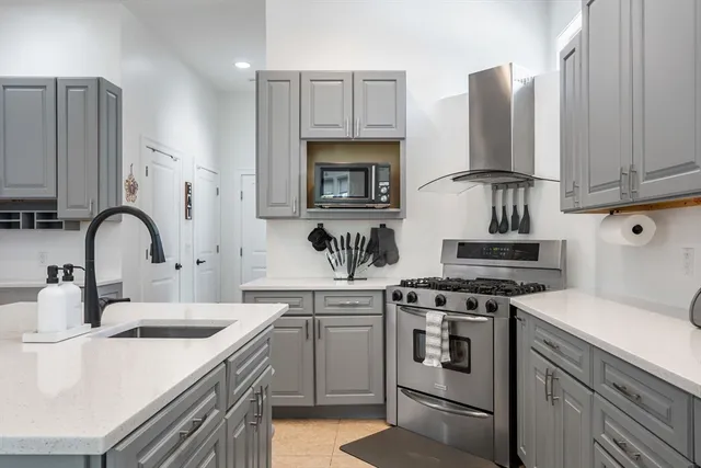 a kitchen with cabinets appliances a sink and a counter top space