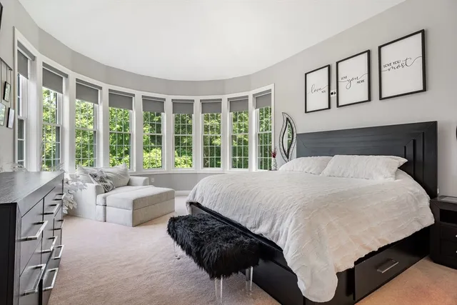 a bedroom with a large bed and a large window