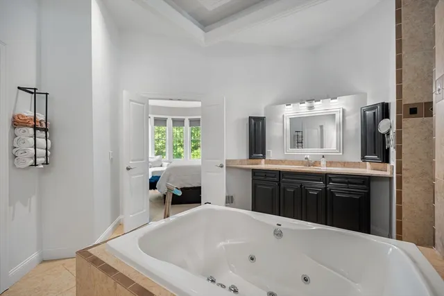 a large white tub sitting in a bathroom