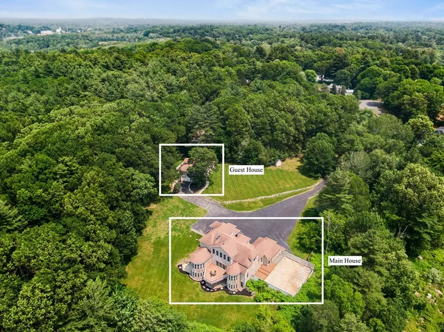 an aerial view of a house with a yard
