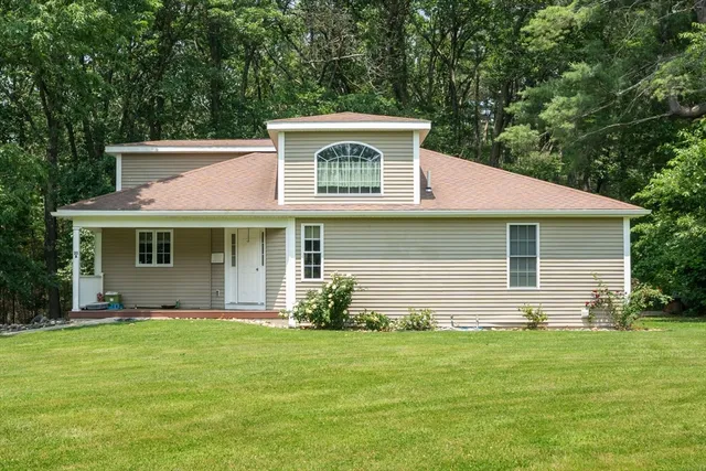 a front view of a house with a garden