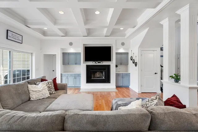 a living room with furniture flat screen tv and a fireplace