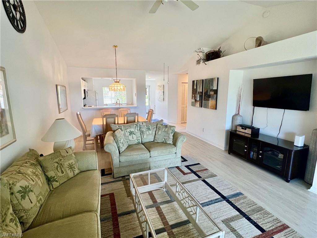 185 Gabriel Circle, Unit 4 Naples, FL 34104 - Photo 11 of 20 a living room with furniture and a flat screen tv