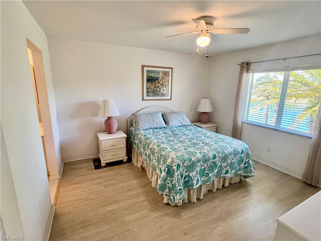 185 Gabriel Circle, Unit 4 Naples, FL 34104 - Photo 15 of 20 a bedroom with a bed and a window