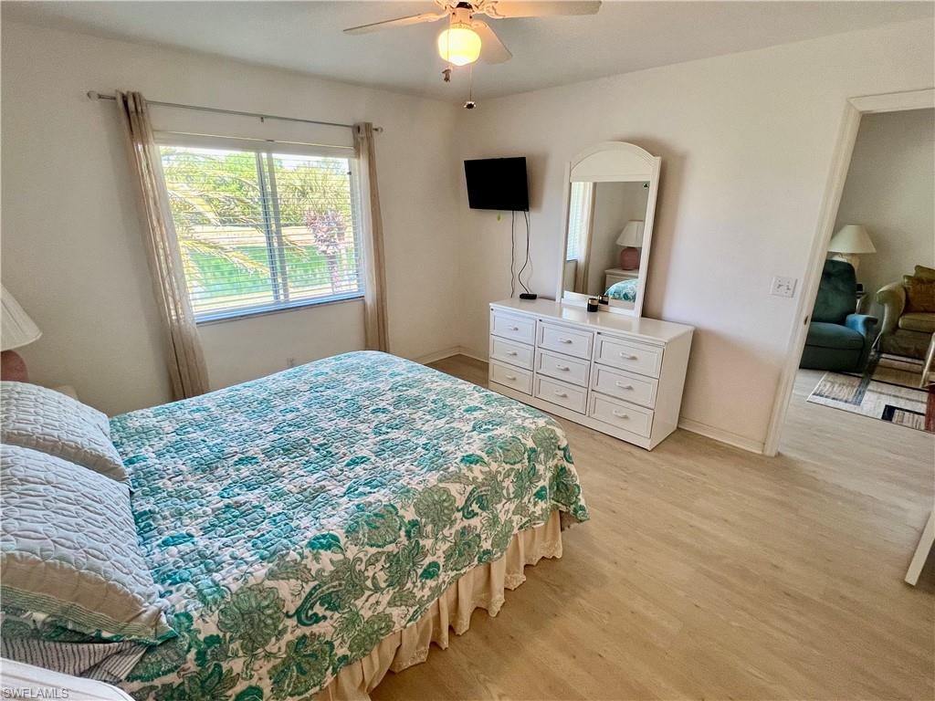 185 Gabriel Circle, Unit 4 Naples, FL 34104 - Photo 16 of 20 a bedroom with a bed and a television