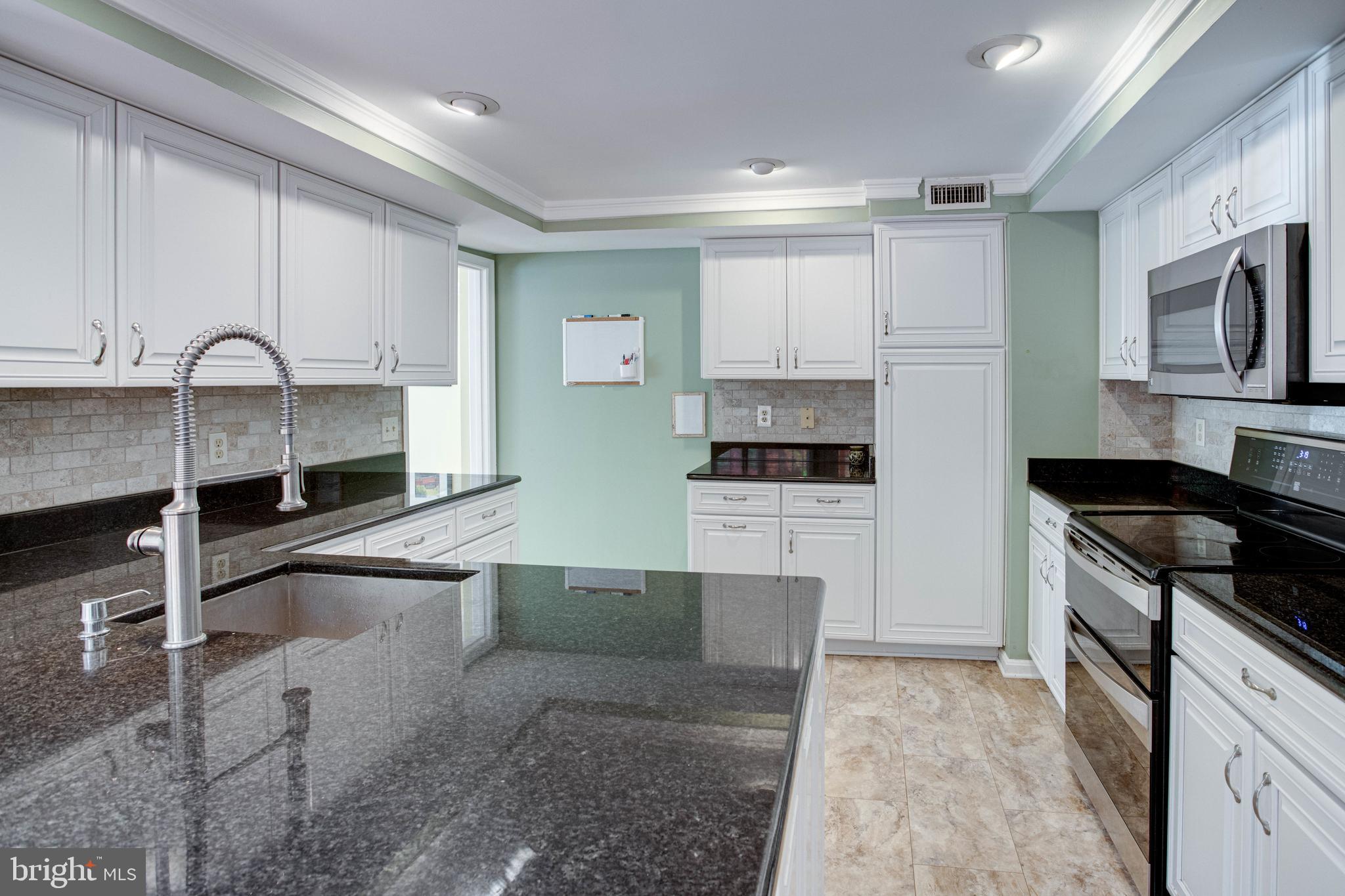 1542 Deer Point Way Reston, VA 20194 - Photo 19 of 68 Kitchen with Granite Counters and Tile Backsplash