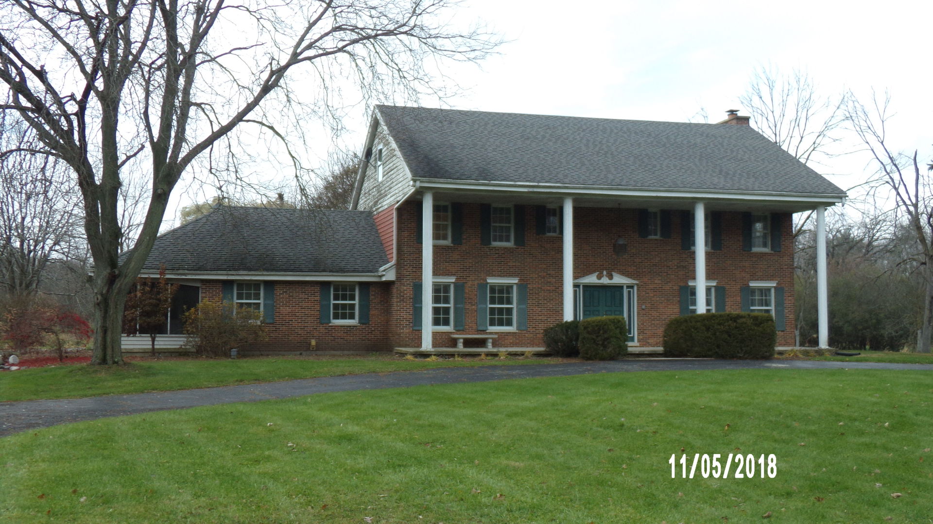 41 Spring Lane Barrington, IL 60010 - Photo 1 of 16 front view of a brick house with a yard