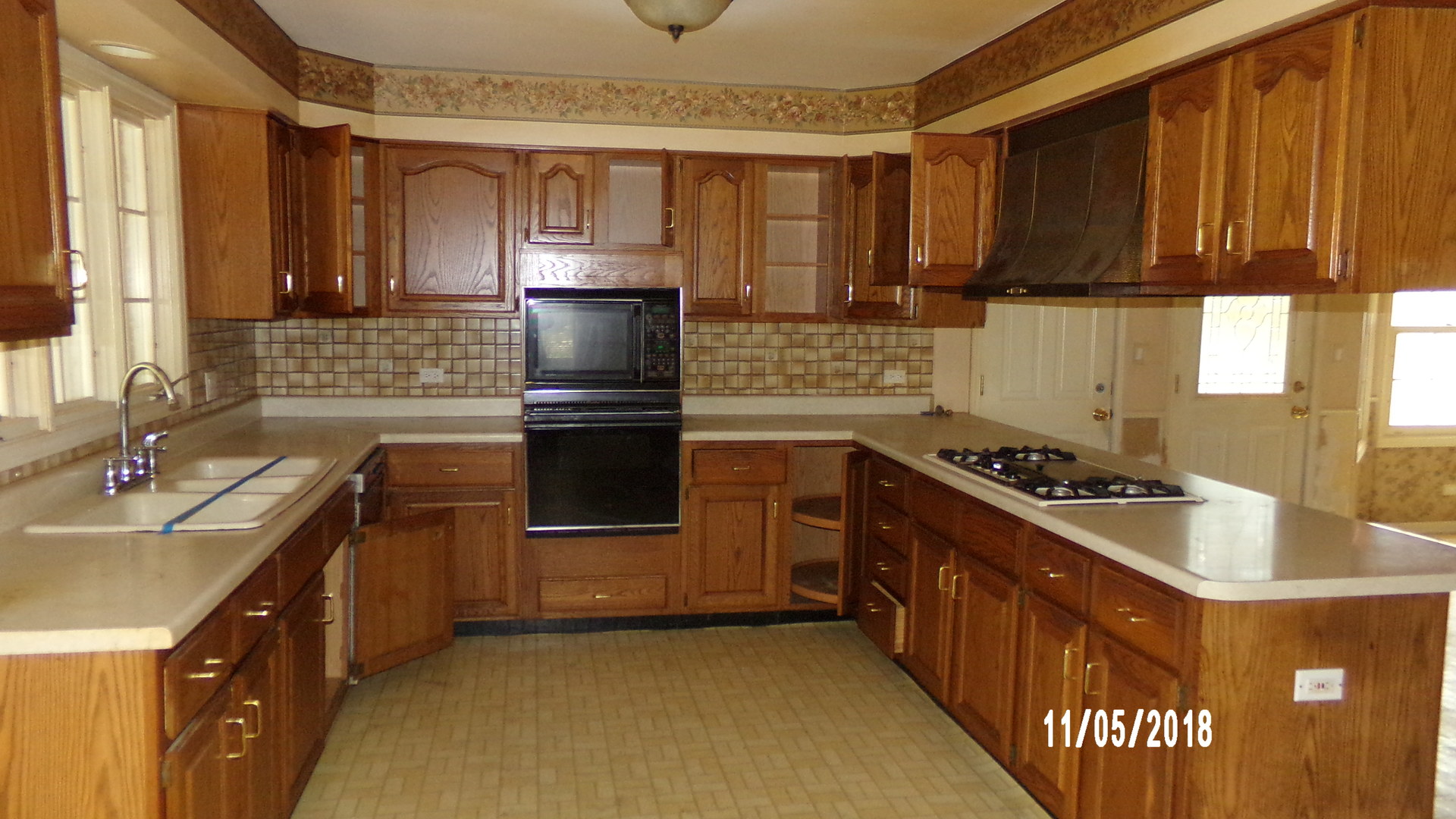 41 Spring Lane Barrington, IL 60010 - Photo 5 of 16 a kitchen with kitchen island granite countertop a sink stove and refrigerator