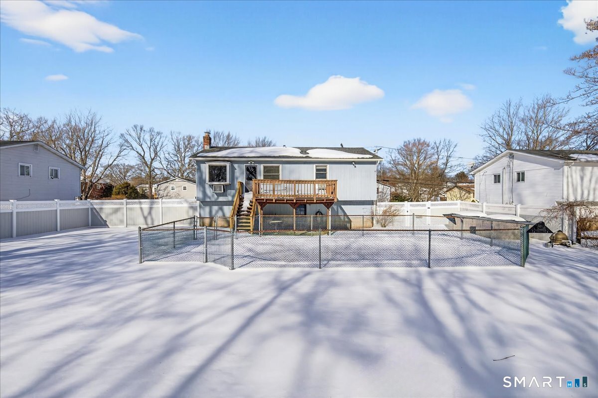80 Flower Drive Hamden, CT 06518 - Photo 27 of 28 a view of a patio with table and chairs floor to ceiling window with wooden floor