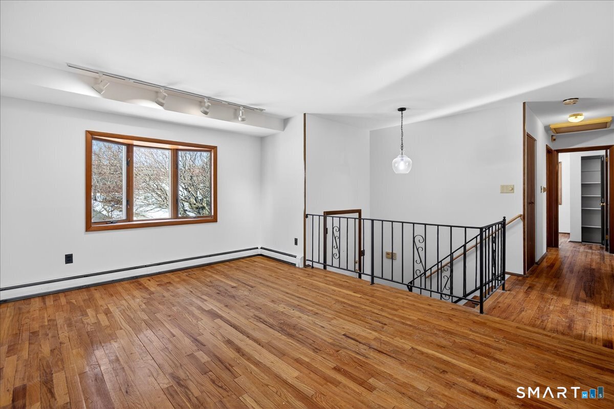 80 Flower Drive Hamden, CT 06518 - Photo 6 of 28 a view of an empty room with wooden floor and a window