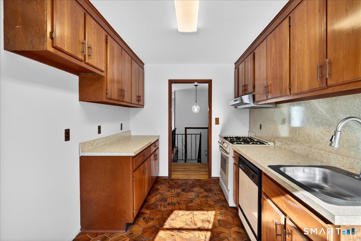 80 Flower Drive Hamden, CT 06518 - Photo 7 of 28 a kitchen with a sink stove top oven and cabinets