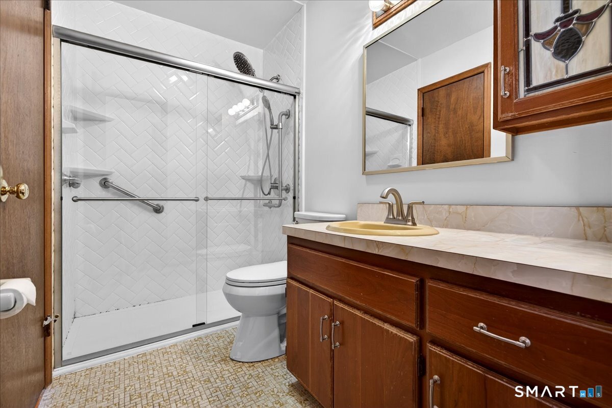 80 Flower Drive Hamden, CT 06518 - Photo 10 of 28 a bathroom with a sink a toilet and shower