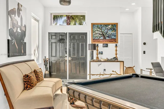 a living room with furniture and a mirror