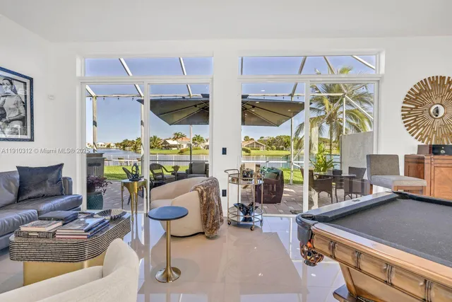 a living room with stainless steel appliances kitchen island granite countertop a stove a kitchen island a dining table and chairs