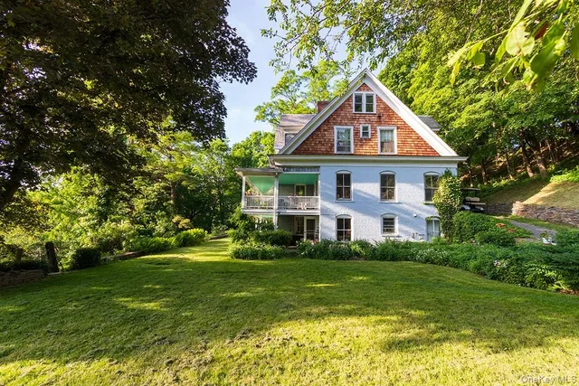 a front view of house with yard and green space