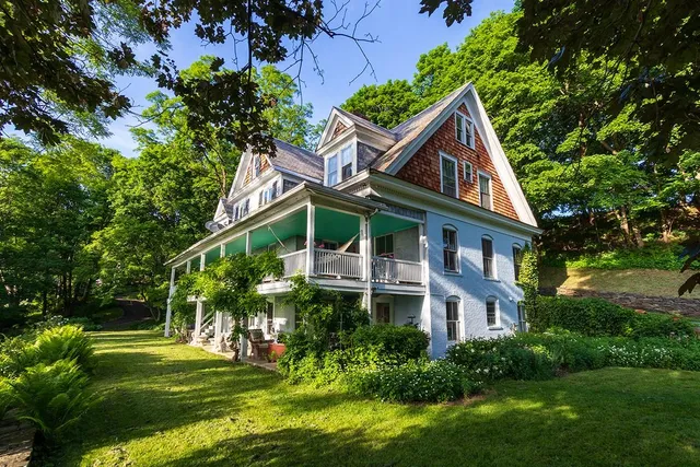 a front view of house with yard and green space