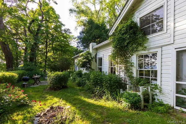 a view of backyard of house with green space