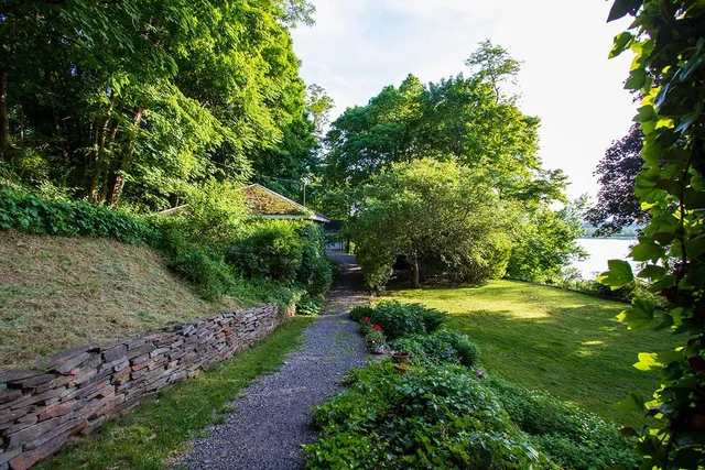 a backyard of a house with a yard and trampoline