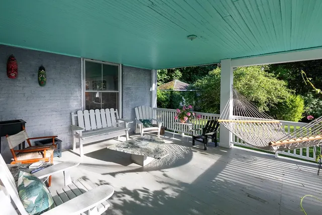 a view of a patio with a dining table and chairs with wooden floor