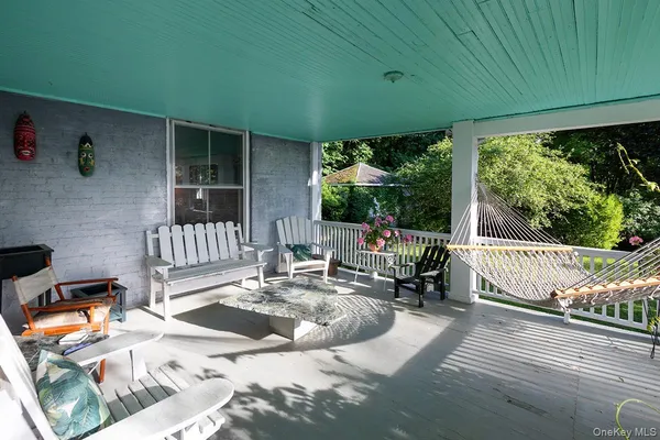 a view of a patio with a dining table and chairs with wooden floor