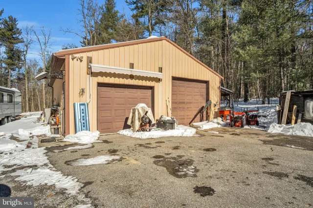 a view of a house with snow on the road