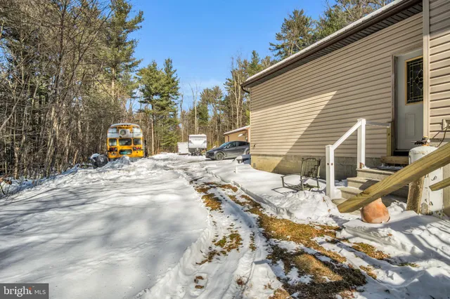 a view of a house with snow on the road