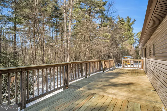 a view of balcony with wooden floor and fence