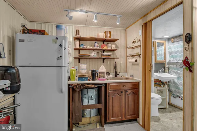 a kitchen with stainless steel appliances granite countertop a refrigerator and a stove