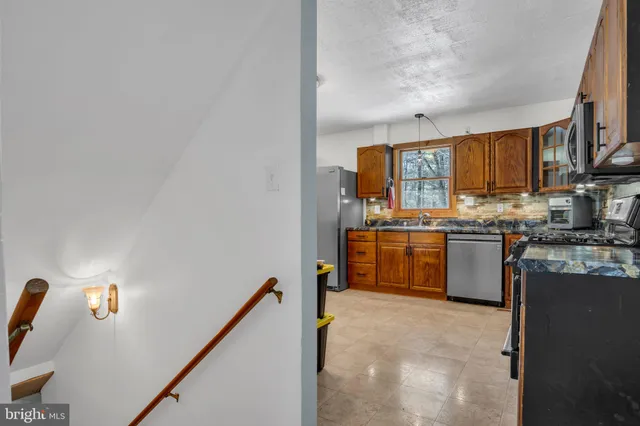 a kitchen with appliances cabinets and a sink