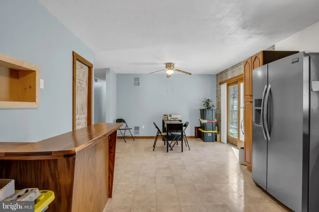 a view of kitchen with furniture and a refrigerator