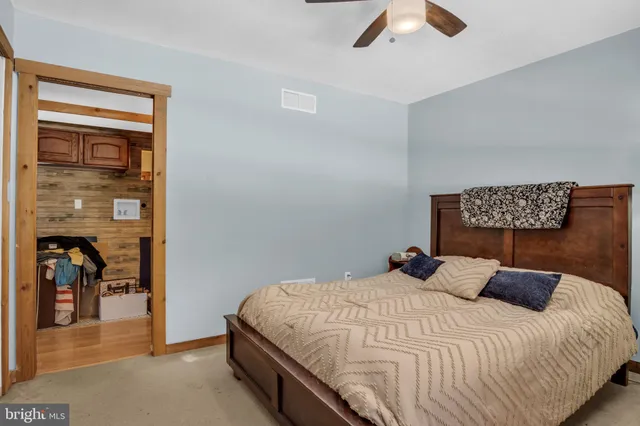 a view of an empty room with window and a ceiling fan