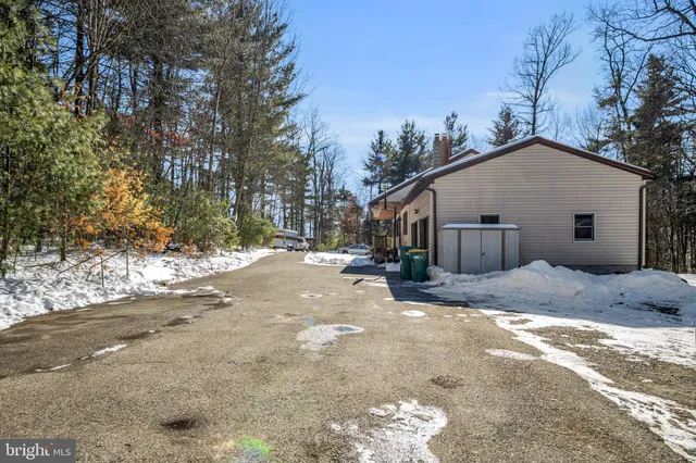 a view of a house with a yard covered in snow