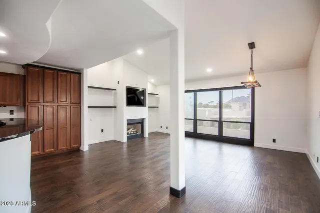 a view of a livingroom with furniture wooden floor and window