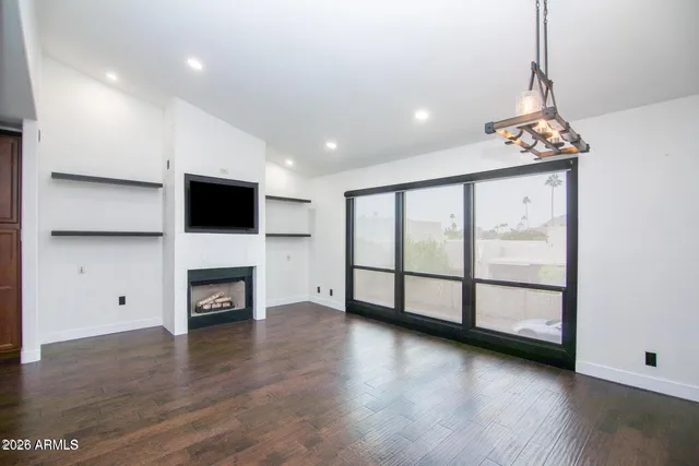 a view of a livingroom with a fireplace a fireplace and window