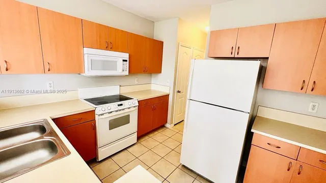 a kitchen with a refrigerator sink stove and cabinets