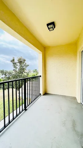 a view of balcony with furniture