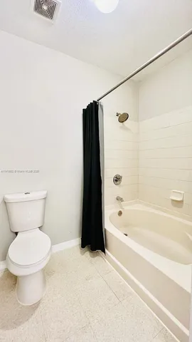 a bathroom with a toilet and a bathtub