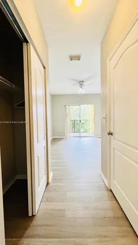 a view of hallway with wooden floor