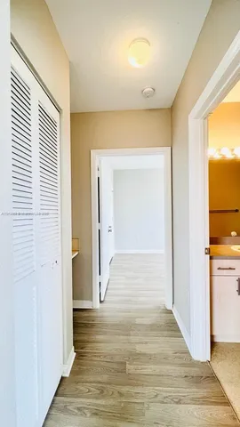 a view of a room with wooden floor and windows