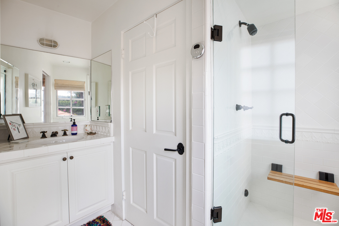 558 East Channel Road Santa Monica, CA 90402 - Photo 20 of 34 a bathroom with a double vanity sink a mirror and shower