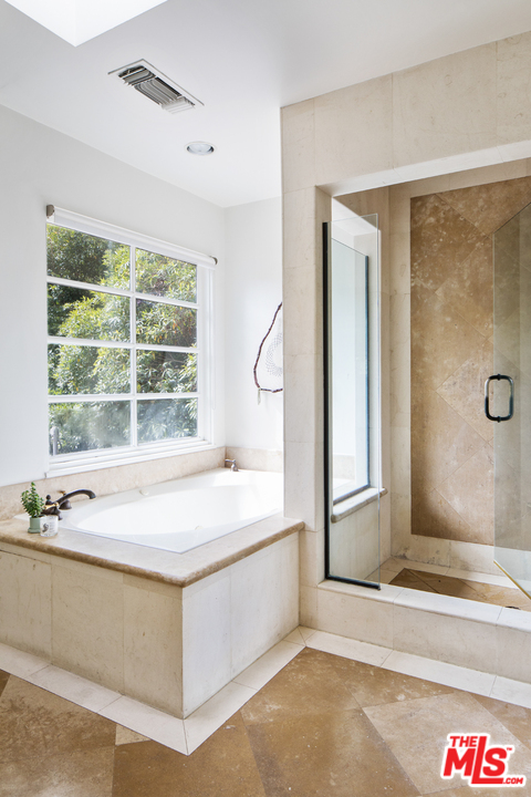 558 East Channel Road Santa Monica, CA 90402 - Photo 25 of 34 a spacious bathroom with a tub and a sink