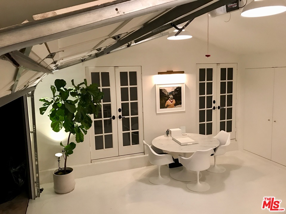 558 East Channel Road Santa Monica, CA 90402 - Photo 28 of 34 a living room with a large window and potted plants
