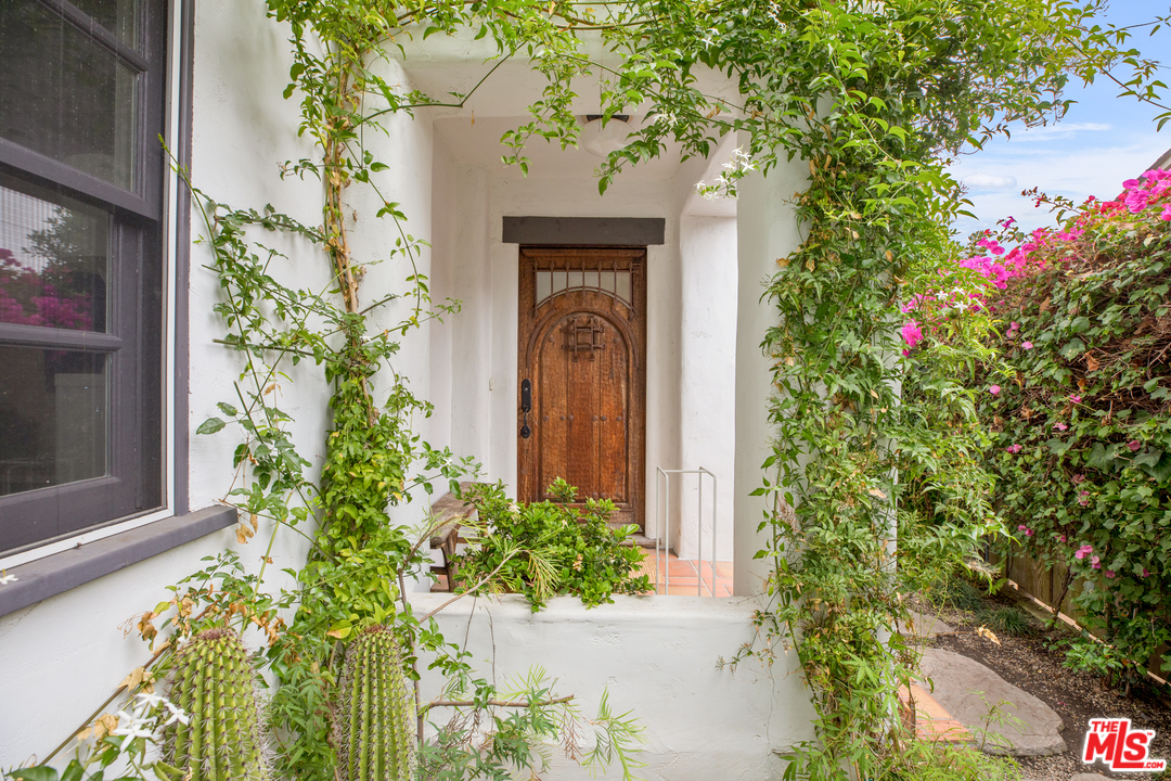 558 East Channel Road Santa Monica, CA 90402 - Photo 6 of 34 a front view of a house with a lot of flower plants