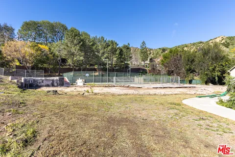 a swimming pool with an outdoor space and seating area