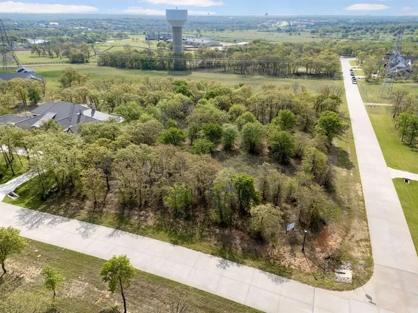 an aerial view of a residential houses with outdoor space and street view