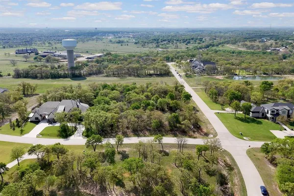 an aerial view of residential houses with outdoor space and city view