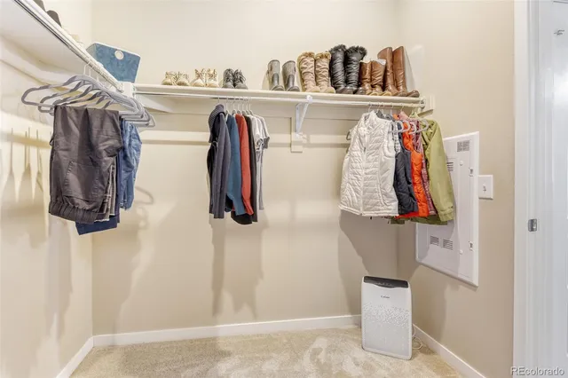 a view of walk in closet with clothes and shoes