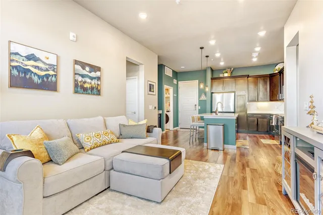 a living room with furniture and kitchen view